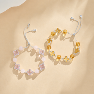 pastel crystal clover bracelets in pink and amber color variations on neutral background