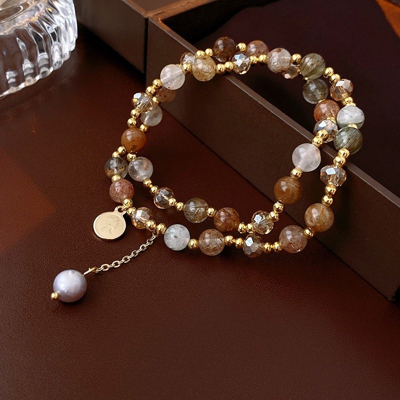 Layered natural stone beaded bracelet with gold-tone beads and crystal charm