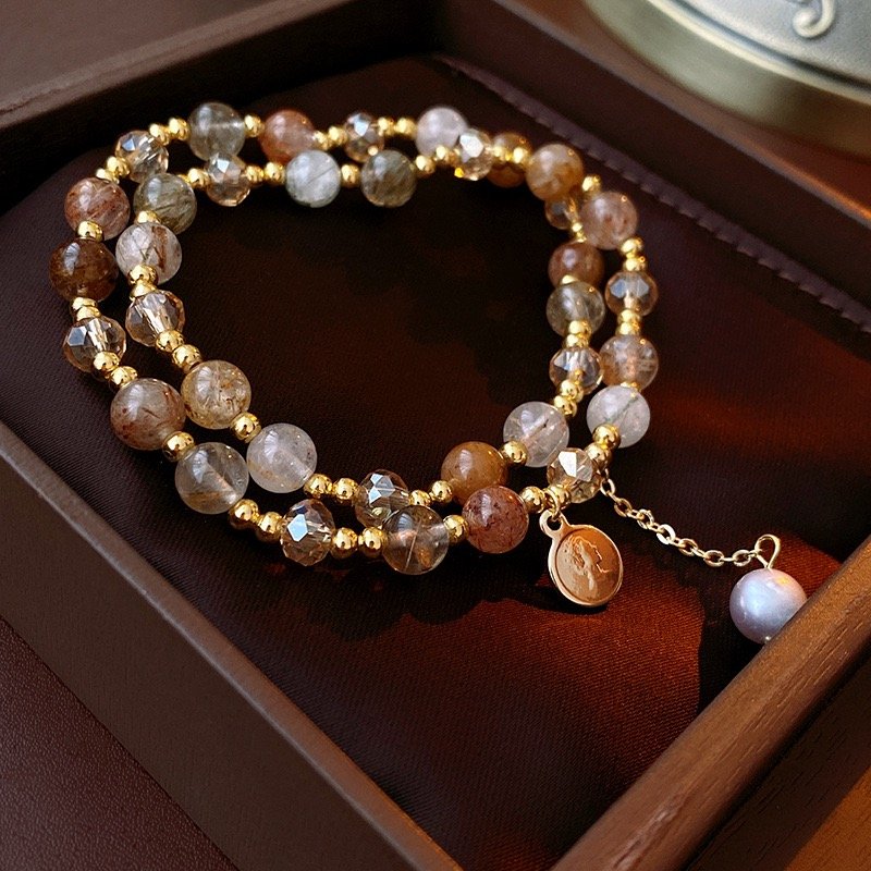 Gold-tone crystal charm wrap bracelet with natural stone-style beads in display box