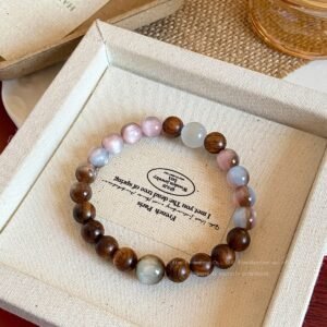 Rosewood cat eye beaded bracelet on vintage fabric tray