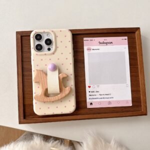 Cream Polka Dot Rocking Horse iPhone Case aesthetic flat lay with wooden stand grip